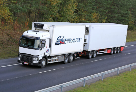 RIIHIMAKI, FINLAND - SEPTEMBER 26, 2015: Renault T reefer truck drives along motorway. Refrigerated trucks can haul a variety of goods that require climate-controlled handling.